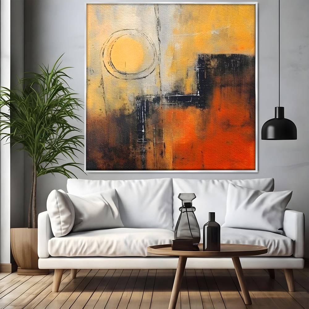 Tablou canvas cu pictura abstracta cu cerc galben, in rama de aluminiu argintiu, pe perete intr-un living